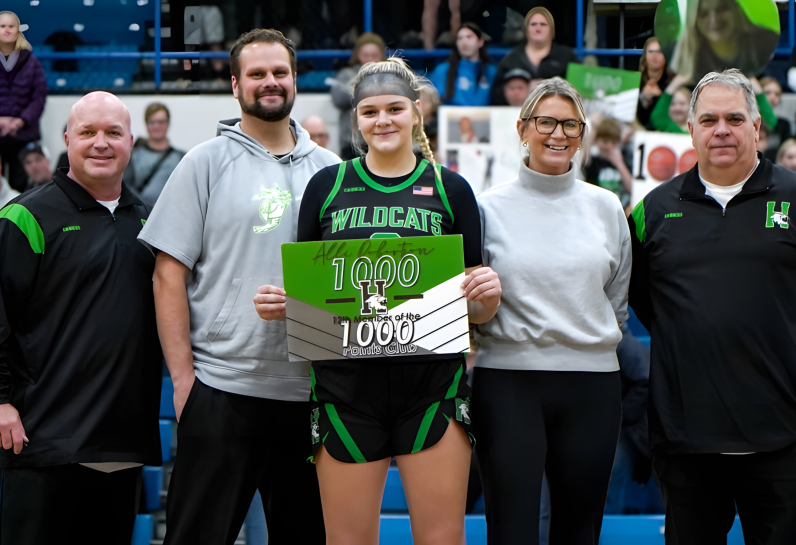 girl with sign for 1000 points club with 4 people around her