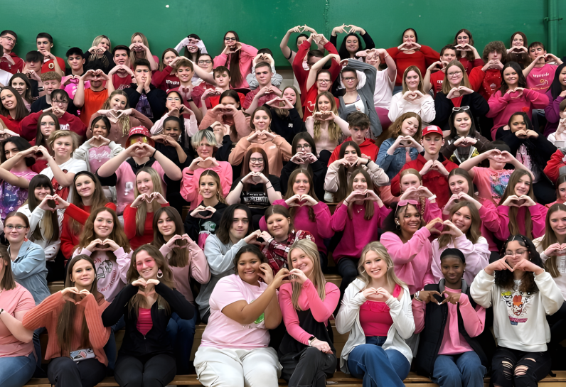 group of students making hearts with their hands